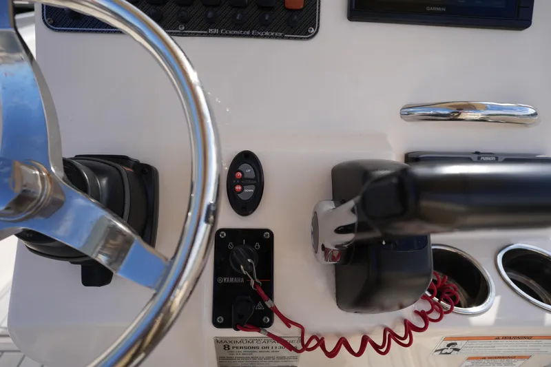 Slide: The Image of 2018 Grady-White 191 Coastal Explorer boat dashboard with steering wheel and controls. - 28