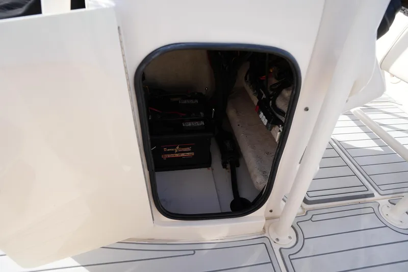 Slide: The Image of 2018 Grady-White 191 Coastal Explorer battery compartment with visible wiring and equipment. - 33