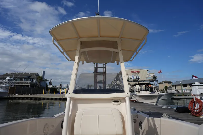 Slide: The Image of 2018 Grady-White 191 Coastal Explorer boat docked at marina under blue sky. - 34