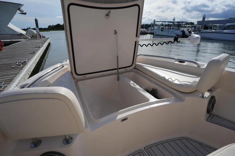Slide: The Image of 2018 Grady-White 191 Coastal Explorer boat interior with open storage compartment at dock. - 38