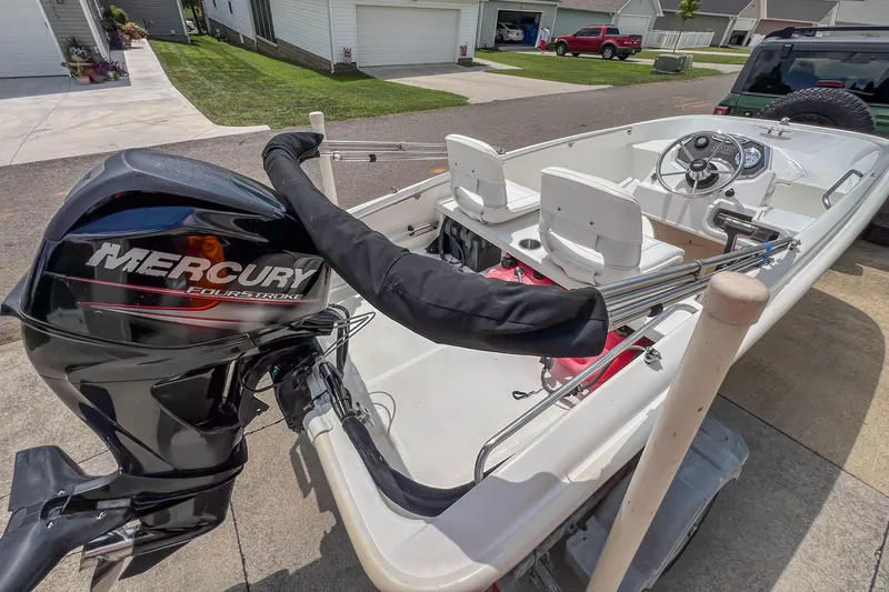 Slide: The Image of 2016 Boston Whaler 130 Super Sport boat with Mercury FourStroke engine, parked in a residential driveway. - 10