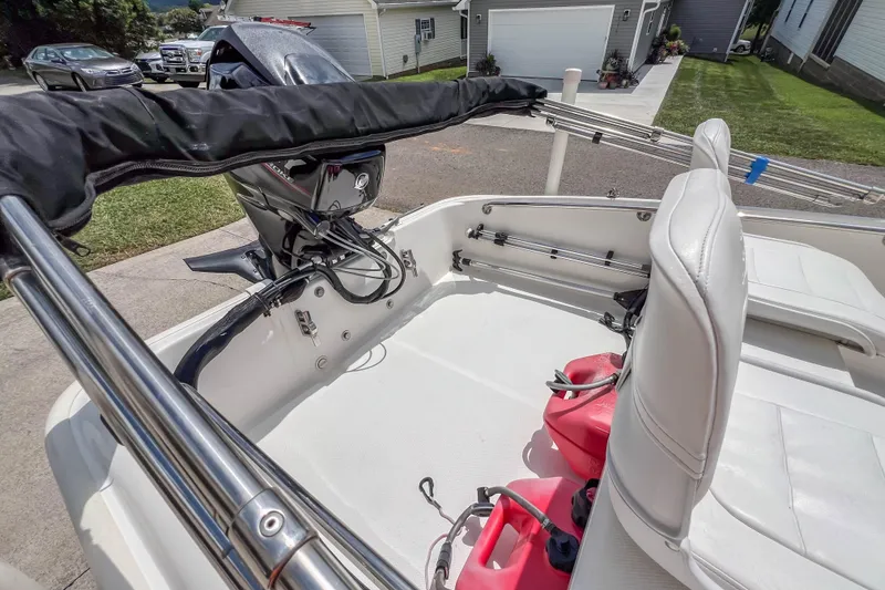 Slide: The Image of 2016 Boston Whaler 130 Super Sport boat interior with motor and seating. - 11