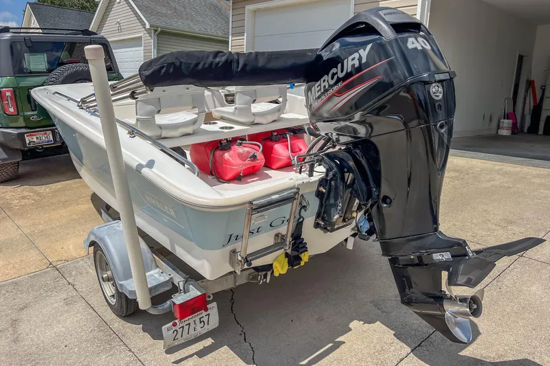 Slide: The Image of 2016 Boston Whaler 130 Super Sport with Mercury engine on trailer in driveway. - 4