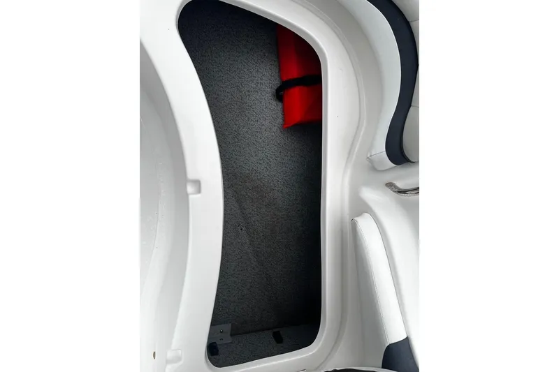Slide: The Image of 2017 Starcraft Limited 2000 OB boat storage compartment with red life jacket. - 15