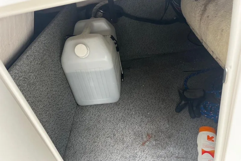 Slide: The Image of Storage compartment in a 2017 Starcraft Limited 2000 OB boat with containers and gear. - 20
