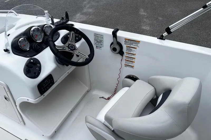 Slide: The Image of Steering console of 2017 Starcraft Limited 2000 OB boat with gauges and controls. - 21