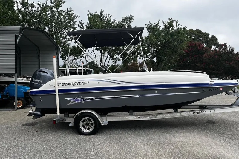 Slide: The Image of 2017 Starcraft Limited 2000 OB boat on trailer, parked outdoors. - 23