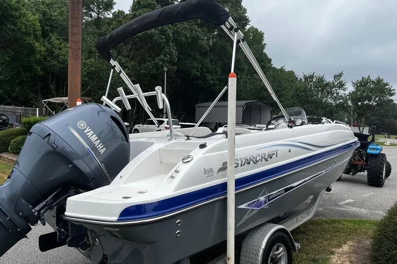 Slide: The Image of 2017 Starcraft Limited 2000 OB boat with Yamaha engine on trailer, parked outdoors. - 4