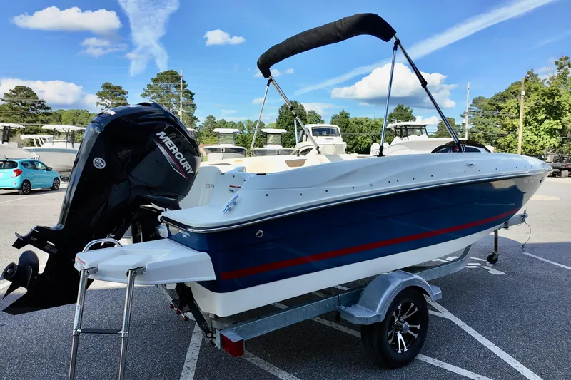 Slide: The Image of 2021 Bayliner Element E18 boat with Mercury engine on trailer, parked outdoors. - 3