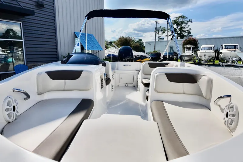 Slide: The Image of 2021 Bayliner Element E18 boat interior with seating and canopy, displayed outdoors. - 4