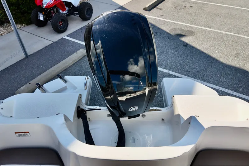 Slide: The Image of 2021 Bayliner Element E18 boat with outboard motor in a parking lot. - 5