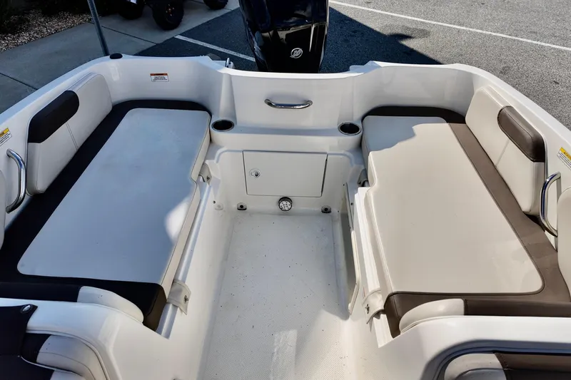 Slide: The Image of 2021 Bayliner Element E18 boat interior with cushioned seating and cup holders. - 7
