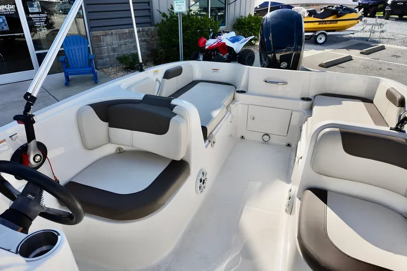 Slide: The Image of 2021 Bayliner Element E18 boat interior with seating and steering wheel. - 8