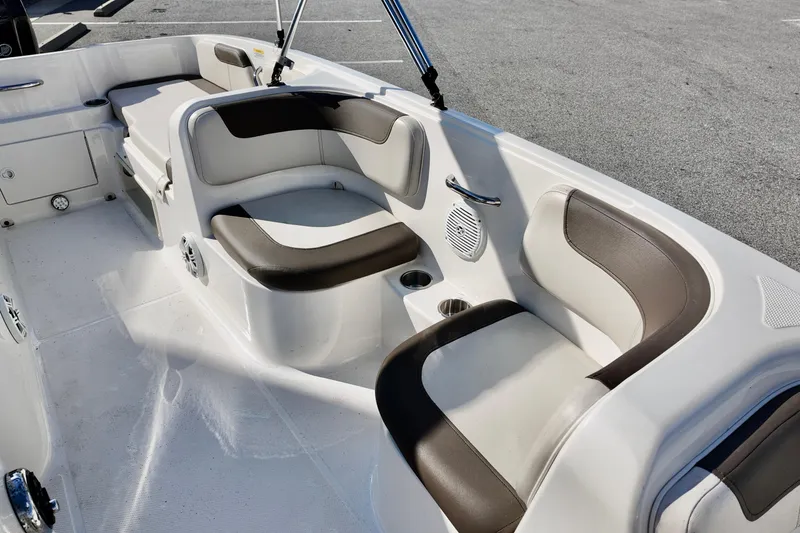 Slide: The Image of 2021 Bayliner Element E18 boat interior with cushioned seating and cup holders. - 9