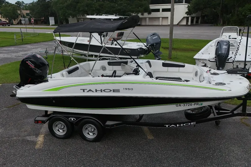 The Image of 2021 Tahoe 1950 boat on trailer, featuring sleek design and powerful outboard motor. - 1