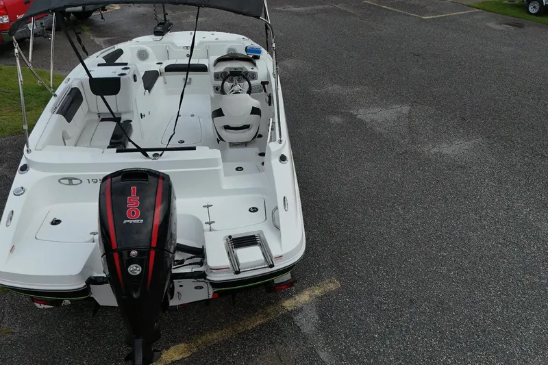Slide: The Image of Aerial view of 2021 Tahoe 1950 boat with 150 Pro motor on asphalt. - 2