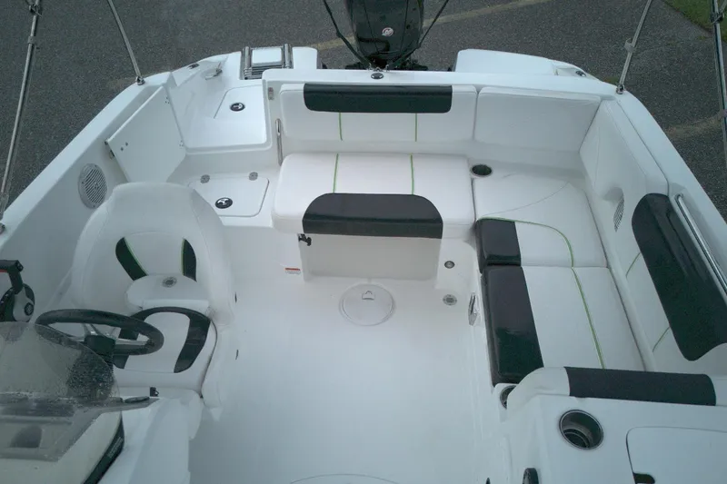 Slide: The Image of Interior of a 2021 Tahoe 1950 boat with white and black seating. - 4