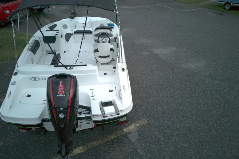 Slide: The Image of 2021 Tahoe 1950 boat with 150 HP engine, parked on asphalt. - 8