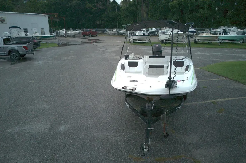 Slide: The Image of Tahoe 1950 boat on trailer in parking lot, surrounded by other boats. - 9