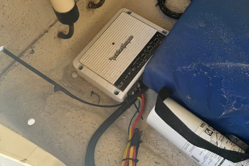 Slide: The Image of 2014 Carolina Skiff 218 DLV interior with audio equipment and safety gear. - 13