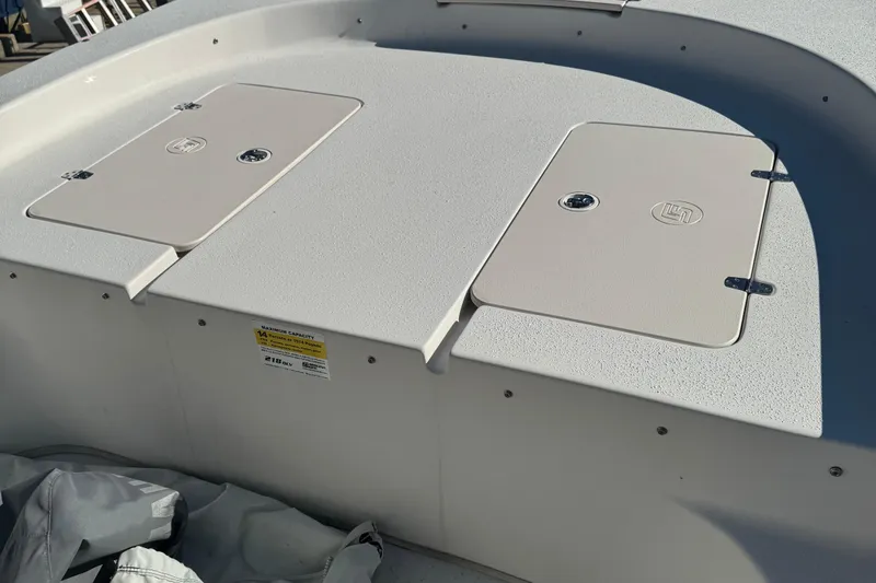 Slide: The Image of 2014 Carolina Skiff 218 DLV boat deck with storage compartments. - 4