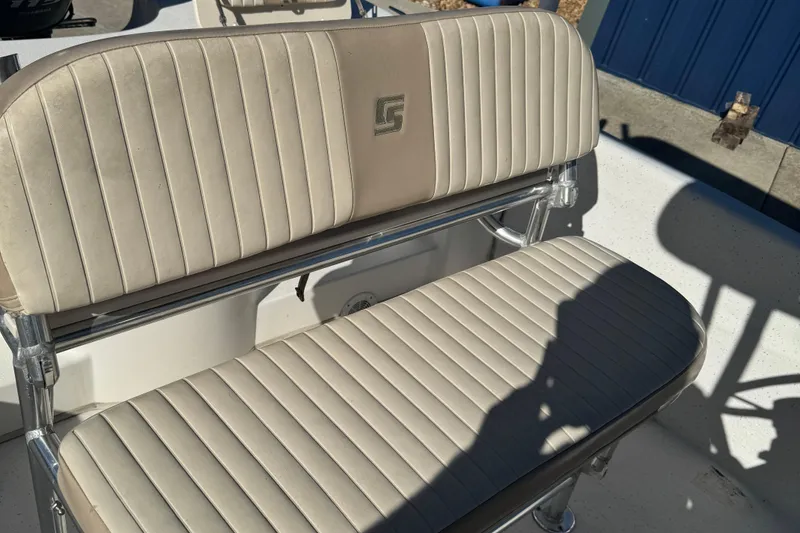 Slide: The Image of 2014 Carolina Skiff 218 DLV boat seat with beige upholstery and logo. - 6