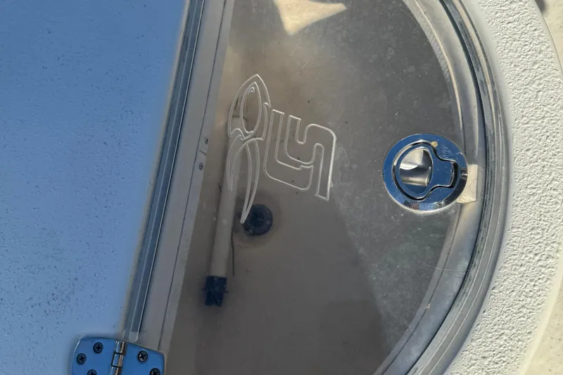 Slide: The Image of 2014 Carolina Skiff 218 DLV boat hatch with logo and latch detail. - 7