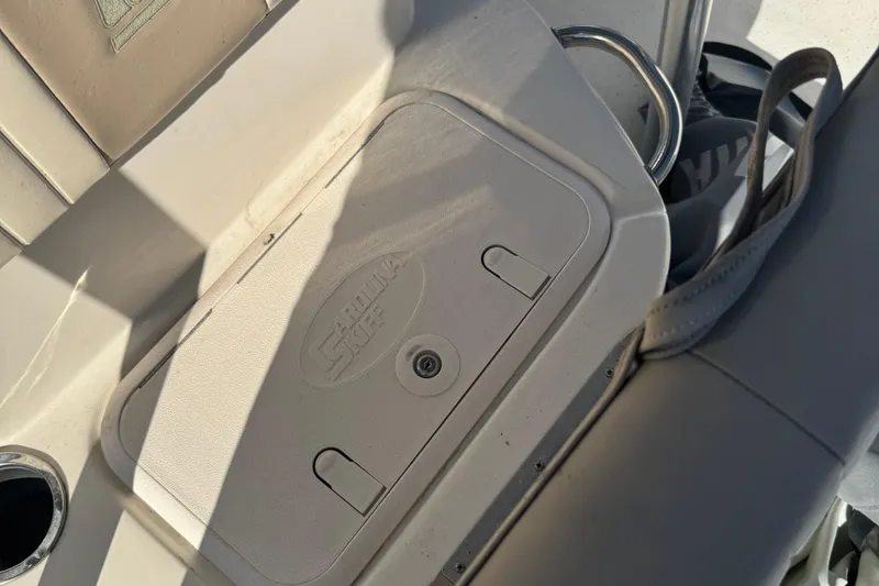 Slide: The Image of 2014 Carolina Skiff 218 DLV boat interior with storage compartment and seating. - 9