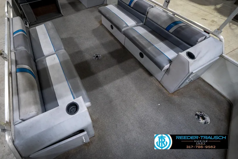 Slide: The Image of 1992 Sun Tracker Party Barge 24 interior with gray seating and carpeted floor. - 13