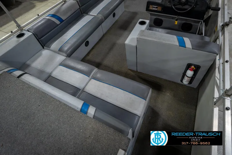 Slide: The Image of 1992 Sun Tracker Party Barge 24 interior with gray seating and carpeted floor. - 14