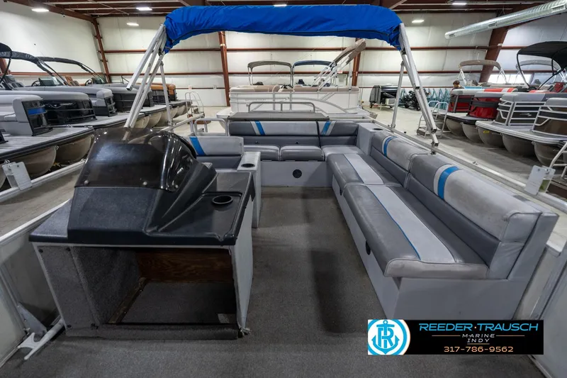 Slide: The Image of 1992 Sun Tracker Party Barge 24 pontoon boat with spacious seating in a showroom. - 17