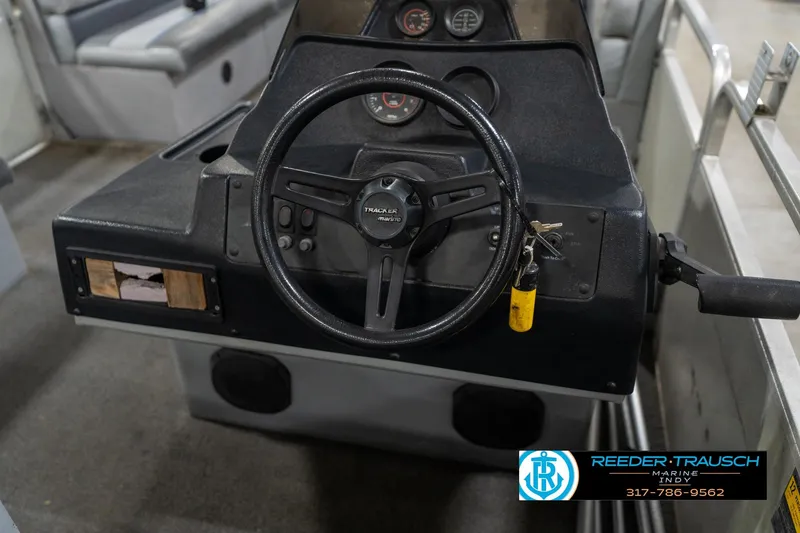 Slide: The Image of 1992 Sun Tracker Party Barge 24 pontoon boat interior with gray and blue seating. - 25