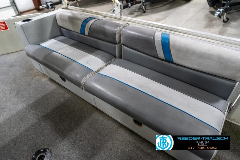 Slide: The Image of Gray seating on a 1992 Sun Tracker Party Barge 24, featuring blue accents. - 34