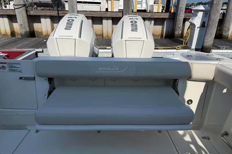 Slide: The Image of 2026 Boston Whaler 285 Conquest boat with dual Mercury engines and foldable seating. - 10