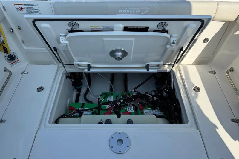 Slide: The Image of Engine compartment of 2026 Boston Whaler 285 Conquest, showcasing battery and wiring. - 13