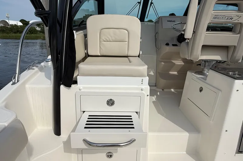 Slide: The Image of 2026 Boston Whaler 285 Conquest interior with seating and helm, showcasing luxury design. - 17