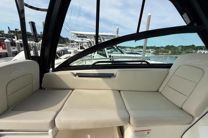 Slide: The Image of 2026 Boston Whaler 285 Conquest interior seating with marina view. - 24