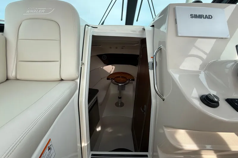 Slide: The Image of 2026 Boston Whaler 285 Conquest cabin interior with Simrad electronics. - 28