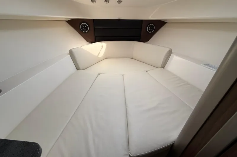 Slide: The Image of Interior cabin of 2026 Boston Whaler 285 Conquest with white cushioned seating. - 31