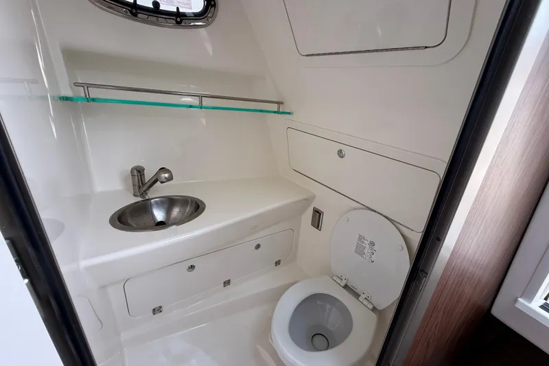 Slide: The Image of 2026 Boston Whaler 285 Conquest boat bathroom with sink, toilet, and storage. - 35