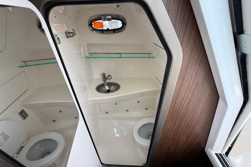 Slide: The Image of Interior of 2026 Boston Whaler 285 Conquest boat bathroom with sink and toilet. - 36