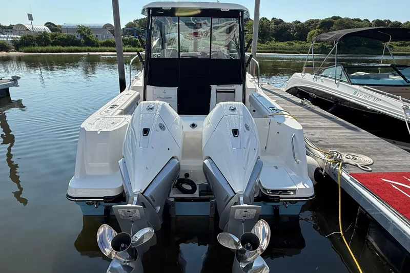Slide: The Image of 2026 Boston Whaler 285 Conquest docked, featuring dual outboard engines. - 4