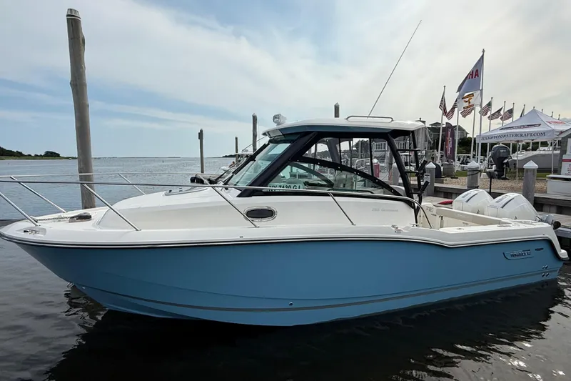 Slide: The Image of 2026 Boston Whaler 285 Conquest boat docked at marina, side view. - 42