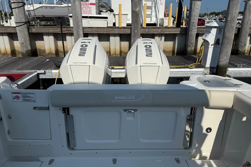 Slide: The Image of 2026 Boston Whaler 285 Conquest with dual Mercury outboard engines at dock. - 9