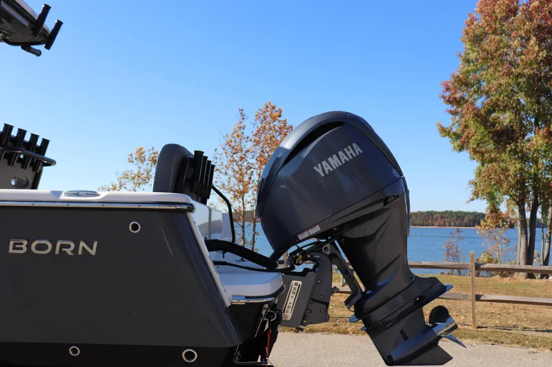 Slide: The Image of 2024 Sea Born LX24 Center Console boat with Yamaha engine by a lake. - 14