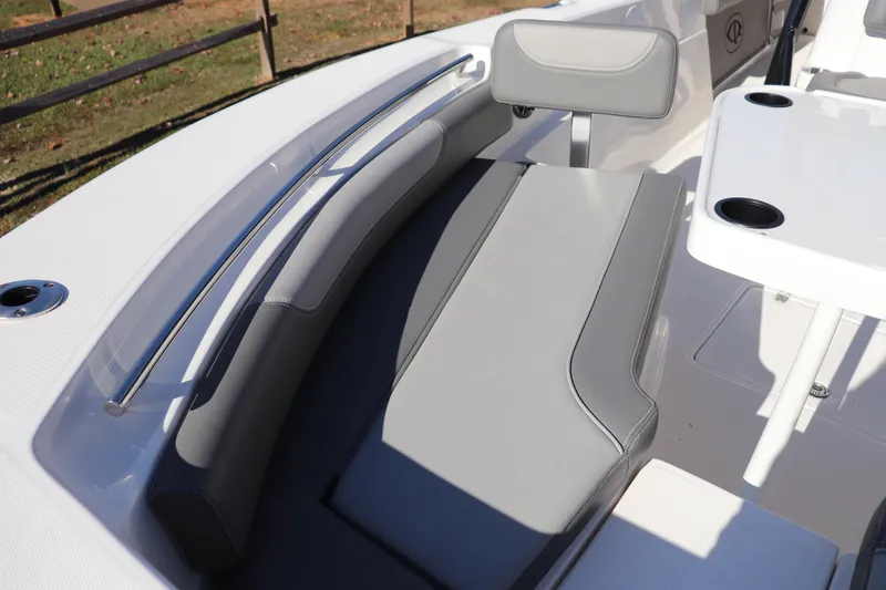 Slide: The Image of 2024 Sea Born LX24 Center Console boat interior with gray seating and table. - 2