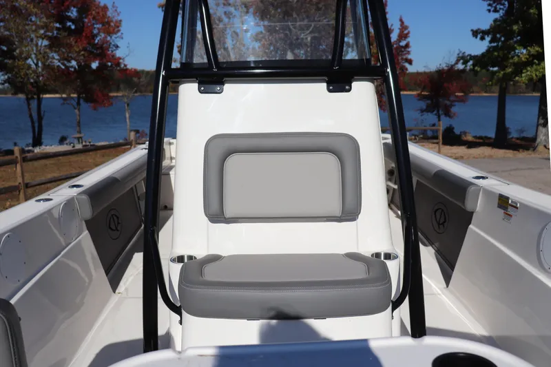 Slide: The Image of 2024 Sea Born LX24 Center Console boat interior with seating, lake view, and autumn trees. - 4