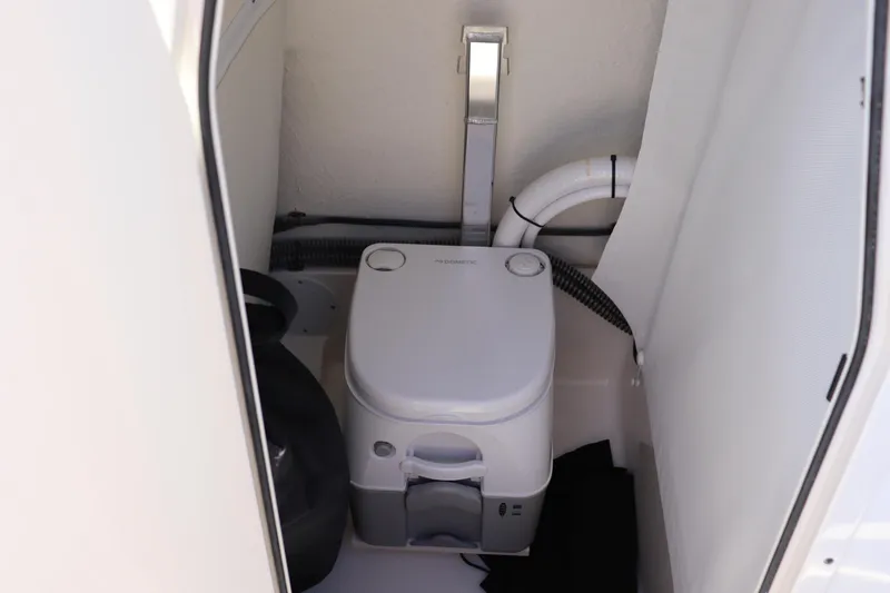 Slide: The Image of 2024 Sea Born LX24 Center Console boat interior with compact marine toilet. - 7