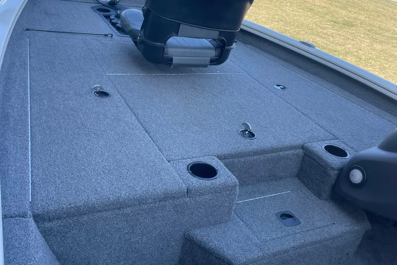 Slide: The Image of 2021 Bass Tracker PT175 boat interior with gray carpet and seating. - 6