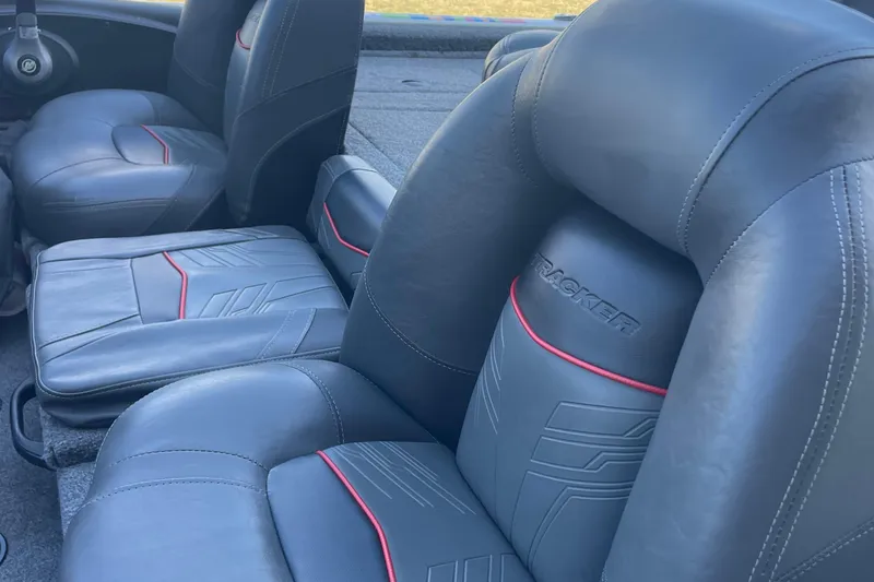 Slide: The Image of 2021 Bass Tracker PT175 boat interior with sleek black and red-accented seats. - 7
